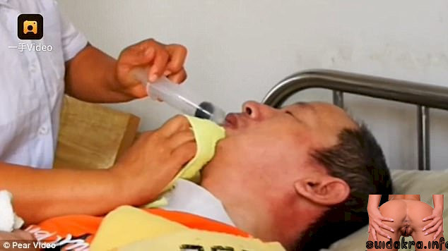 mouth into he feeds food liquid wife syringe